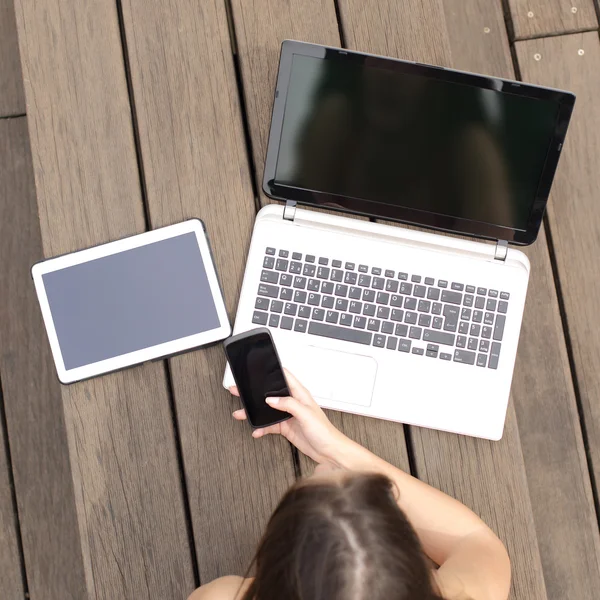 Girl searching job in multiple devices screens