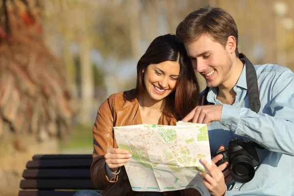 Tourists searching in a map outdoors