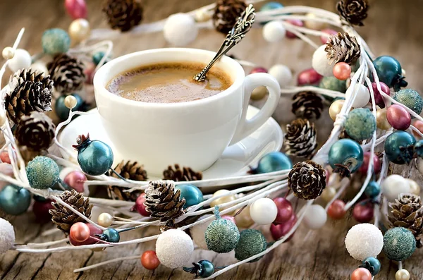 Cup of coffee and Christmas garland wreath