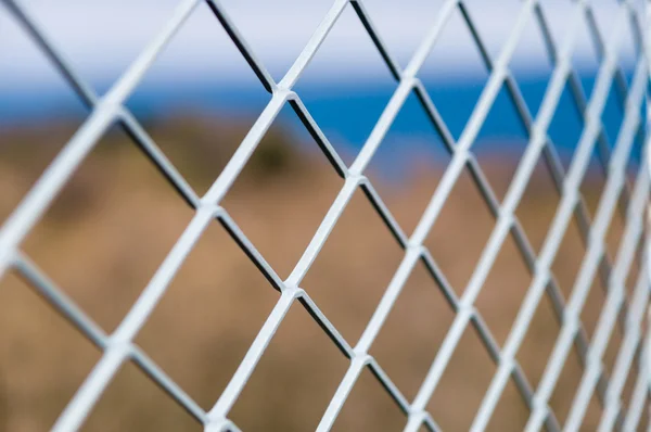 Solid metallic mesh fence