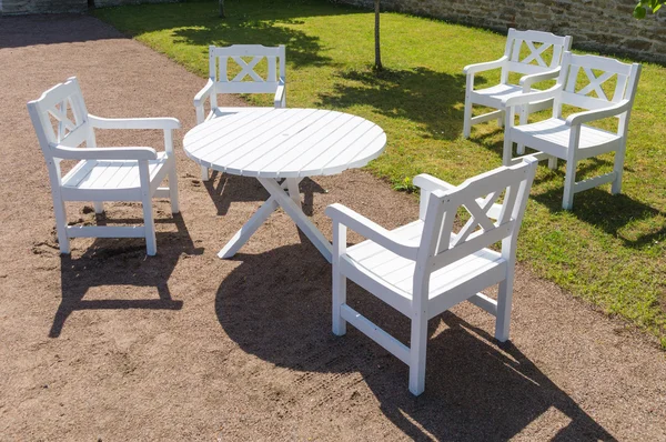 White round table and chairs in garden, terrace furniture
