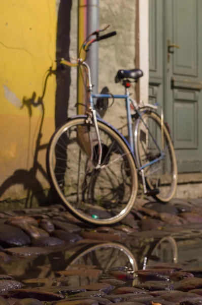 Vintage bike parked on cobbled street of old town