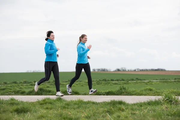 Two women jogging outdoors