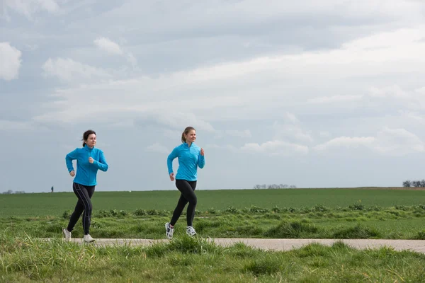 Two women jogging outdoors