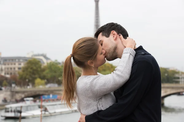 Young couple in Paris kissing