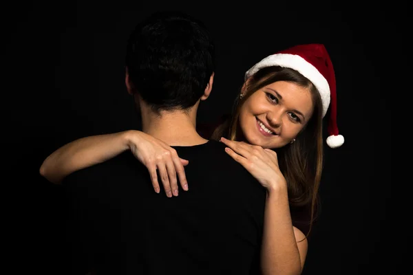 Young couple on black background