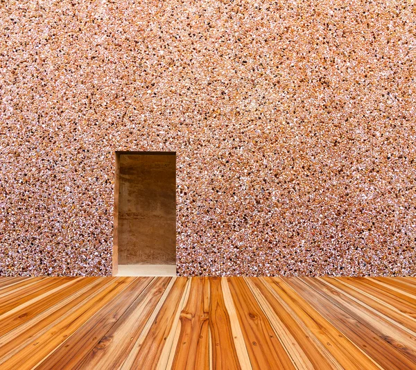 Parete di pietra con porta e pavimento di legno nella parte ...