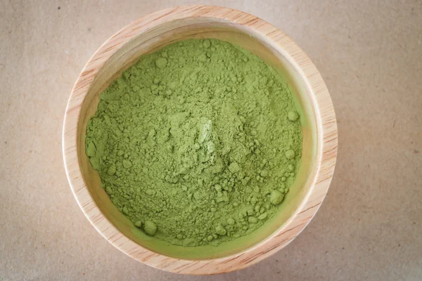 Premium green tea powder in wooden bowl