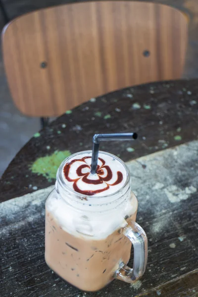 Glass of ice chocolate drink on the table