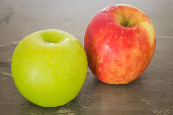 Green and red apple on the table