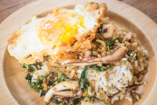Rice topped with stir-fried squid basil and fried egg (Thai food