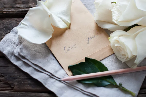 Message Love You on vintage Letter, Pencil, White Roses