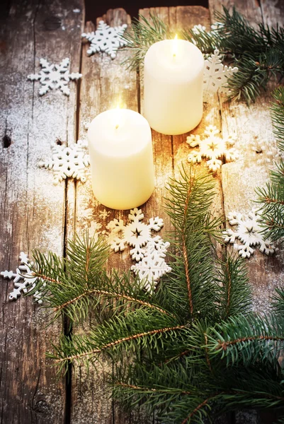 Festive Burning Candles with Christmas Decor Snowflakes and Green Fir Tree