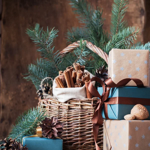 Christmas Card. Festive Gifts with Boxes, Coniferous, Basket, Cinnamon, Pine Cones, Wallnuts