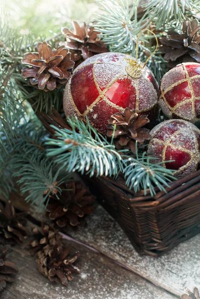 Christmas Red Balls in Basket with branches of Fir Tree, Pine Cones
