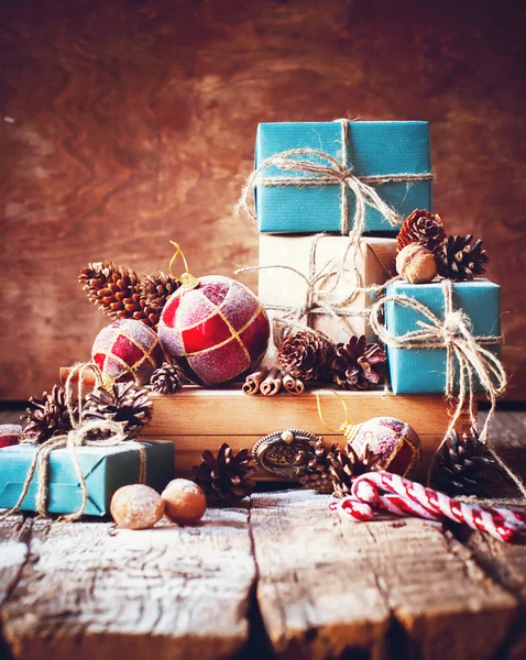 Holiday Christmas Gifts with Boxes and Fir Tree Toys on Wooden Background. Toned image