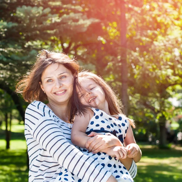 Happy Smiling Mother and Daughter playing in Summer Day. Sunlight