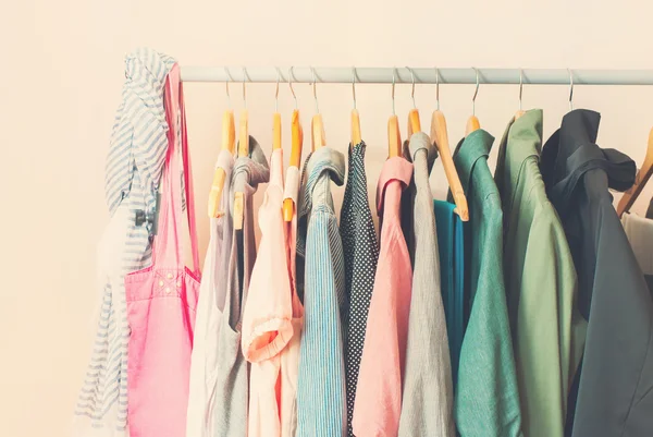 Pastel Color Female Clothes in a Row on Open Hangerl. Toned