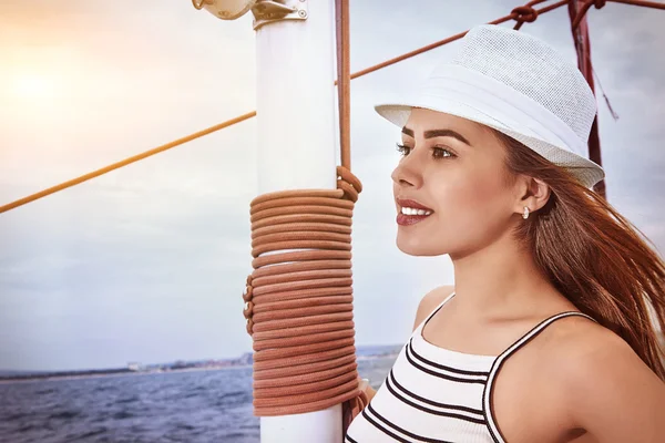 Beautiful smiling woman on a yacht, summertime concept