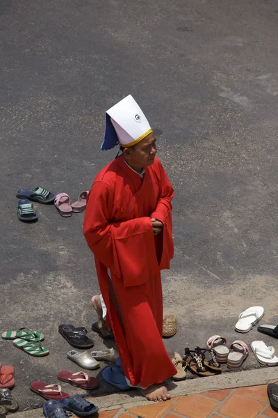 Priest going in a Caodai temple in Vietnam