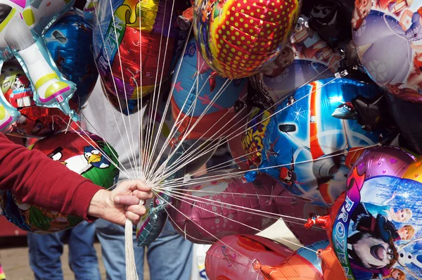 Balloon seller holding colorful balloons