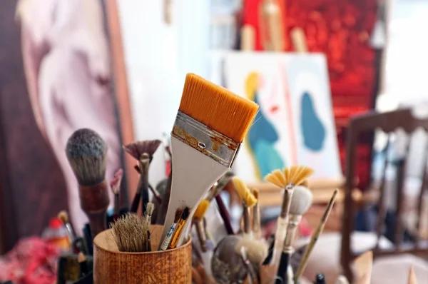 Artist brushes in a studio