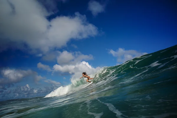 Watersport Activity in Indonesian island Bali Surfing Girl Riding on Wave