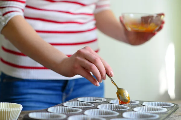 Woman hand prepare healthy muffins with jam