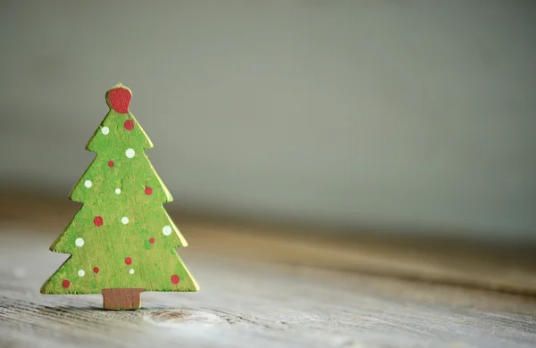 Christmas green tree ornament on wood background