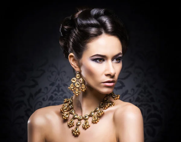 Woman in jewels of gold and stones