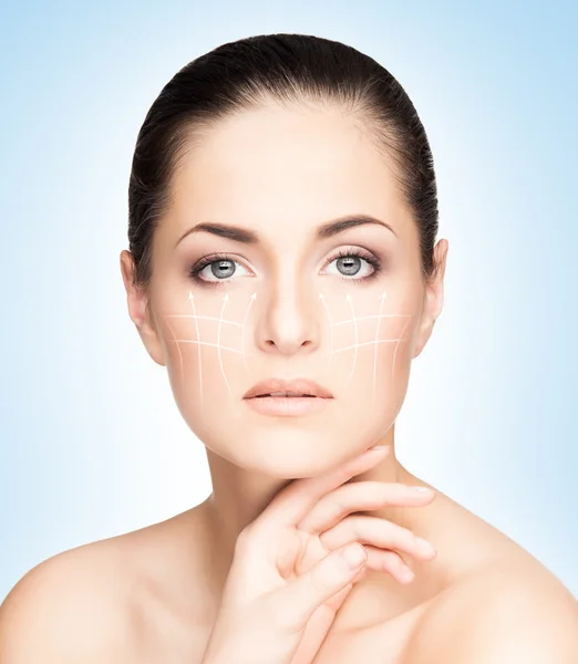 Healthy woman face with arrows