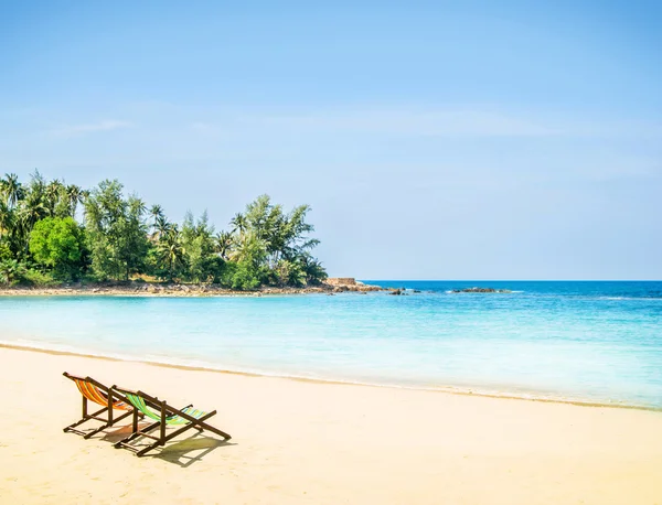 Lounge chairs on tropical beach