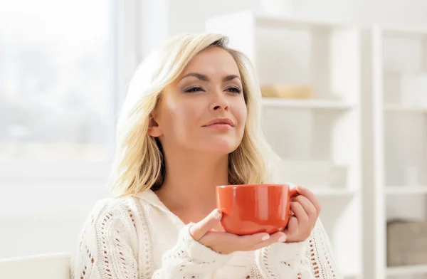 Attractive woman enjoying the smell of coffee in the morning