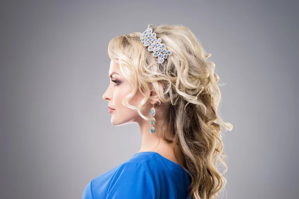 Young blond woman in beautiful hair and jewelry