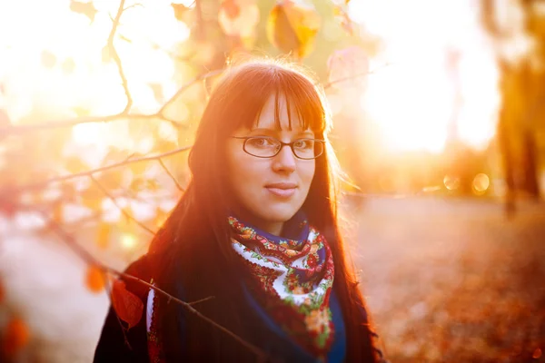 Real woman in glasses in autumn park