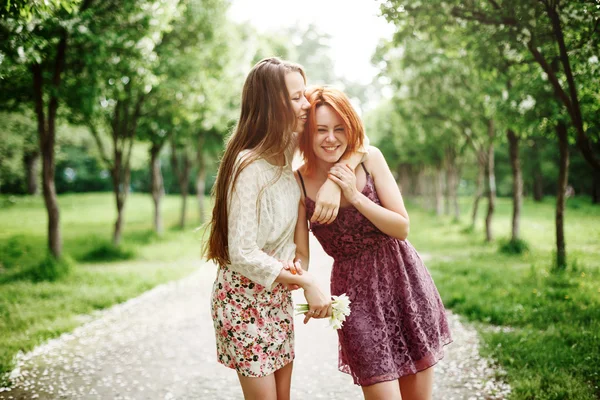 Two Young Happy Girls Having Fun in the Park