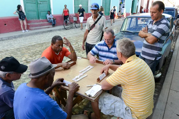 People on the street of Trinidad playing domino