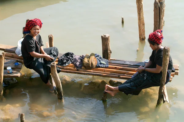 Women washing clothes on the river at Indein on Inle Lake