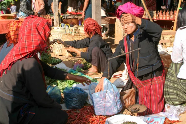 People on traditional clothes at the weekly market at Indein