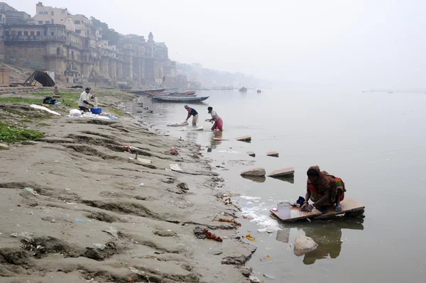 People washing clothes at ghats on the banks of Ganges river