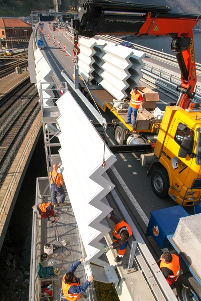 Workers during the installation of noise barriers