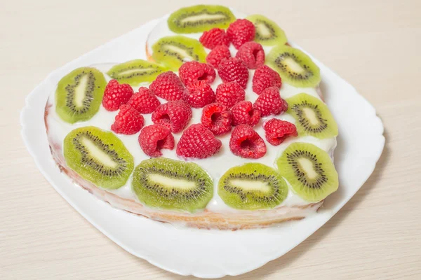 Heart cake decorated with fruits and berries