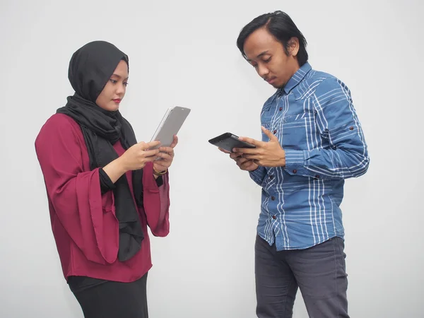 A couple using mobile devices