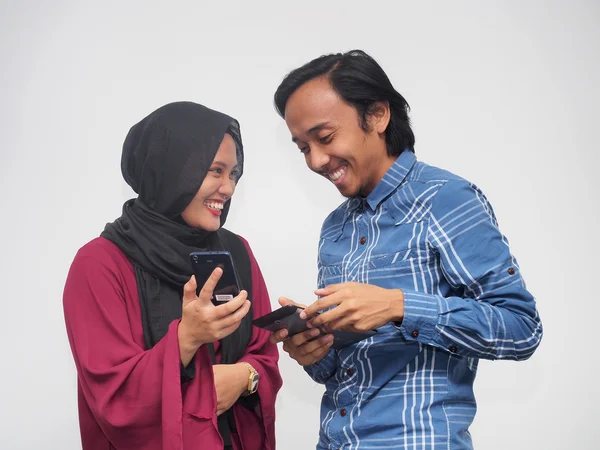A couple using mobile devices