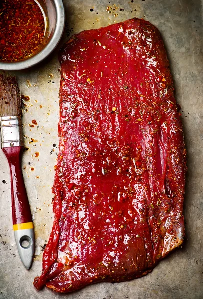 Crude flank steak ready for a grill