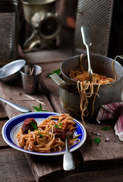 Meat balls in tomato sauce wirh spaghetti.