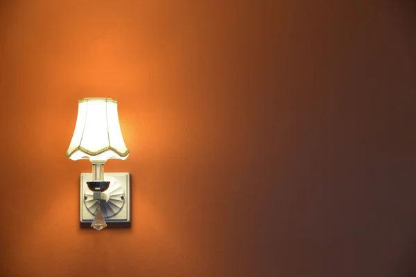 The lamp orange in the room.