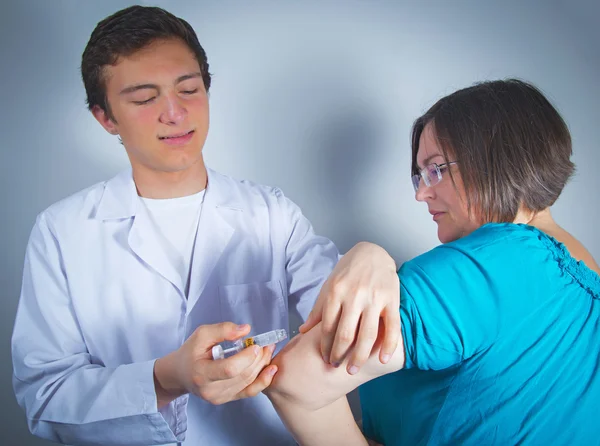 Male nurse giving intravenous therapy