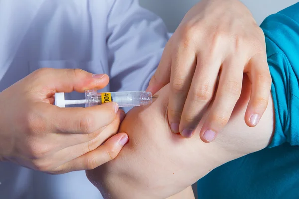 Male nurse giving intravenous therapy