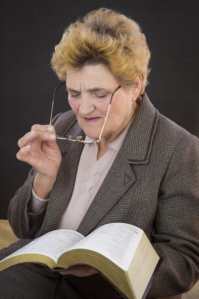 Senior woman reading holly bible